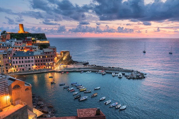 Pink sunset in Ligurian city Vernazza in Italy Cinque Terre Mediterranean culture