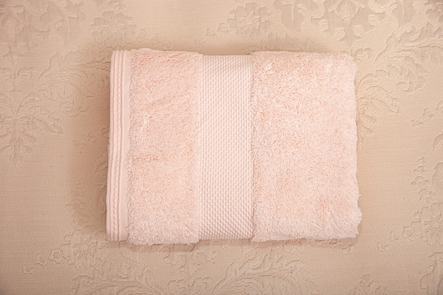 Pink towel, on a milky-beige background. Macro