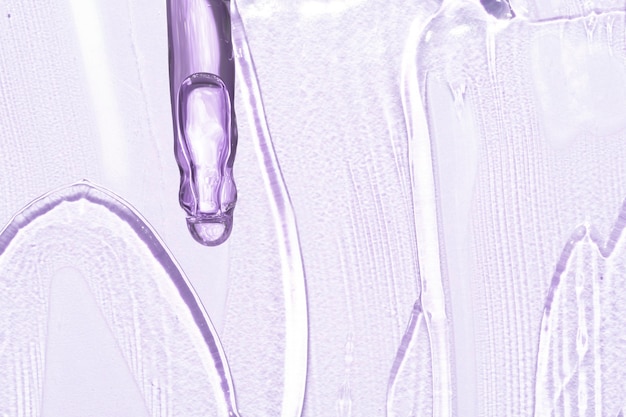 Pink transparent gel macro close up texture with pipette dropper