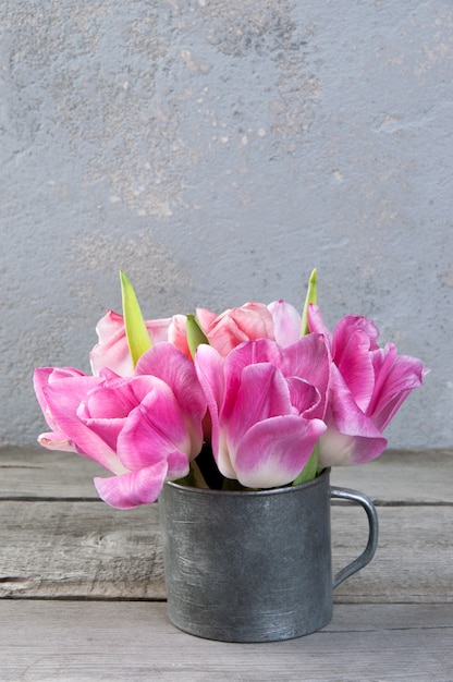 Pink tulips in vintage metal cup