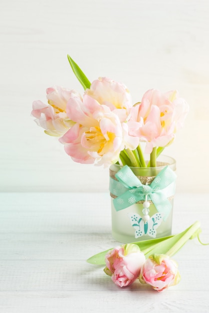 Pink tulips on a white wooden background