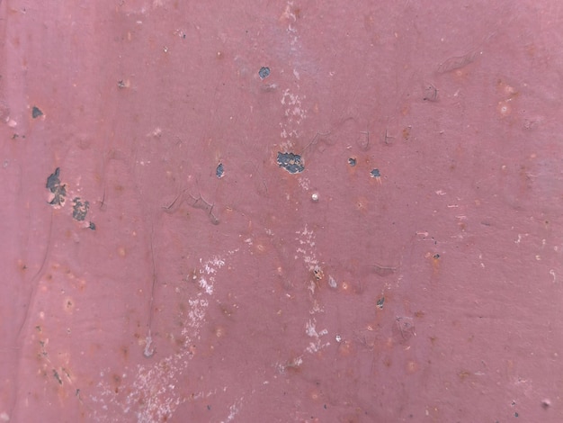 A pink wall with a blue stain in the middle.