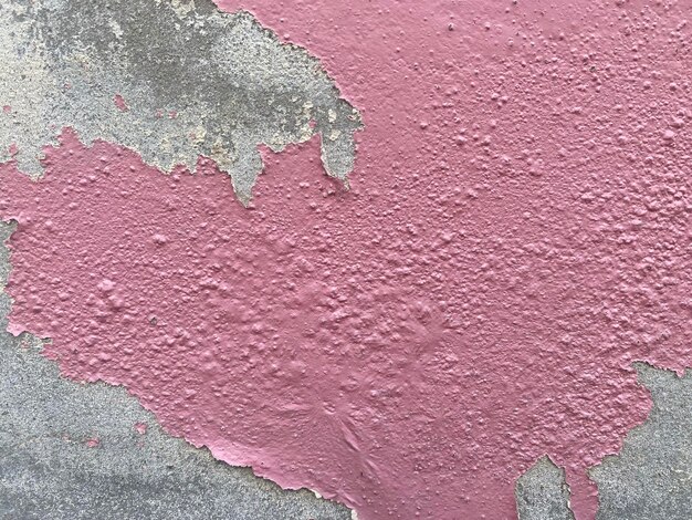 A pink wall with a gray and gray background and a pink paint texture.