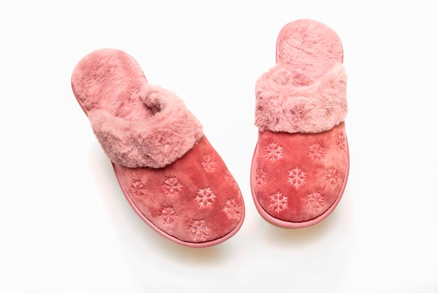 Pink warm women's slippers on a white background