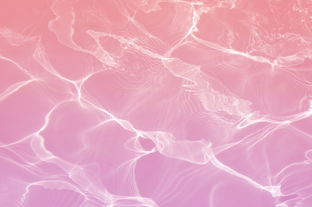 Pink water surface with bright sun light reflections