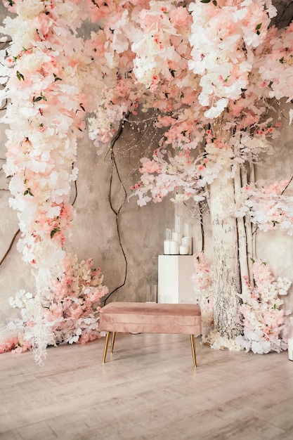 Pink wedding photo zone in studio made of white flowers