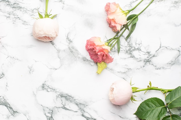 Pink and white flower bouquet on marble background with copyspace