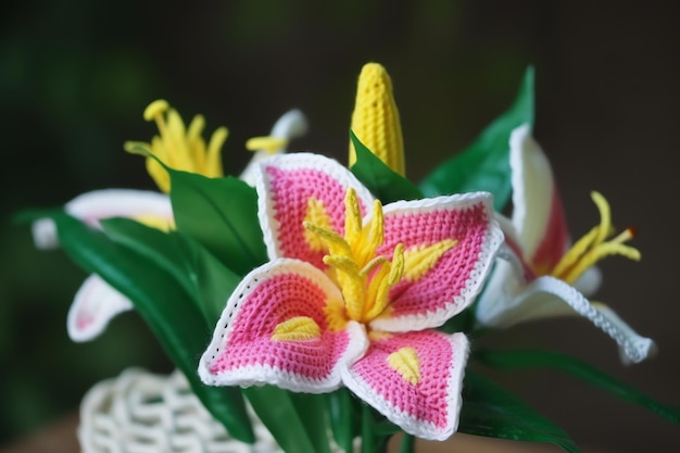 A pink and white flower with yellow flowers in a vase.