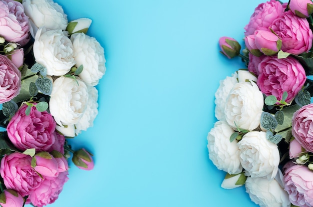 Pink and white flowers on blue background