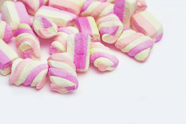 Pink and yellow Marshmallows on lignt background. Pastel colored dessert.