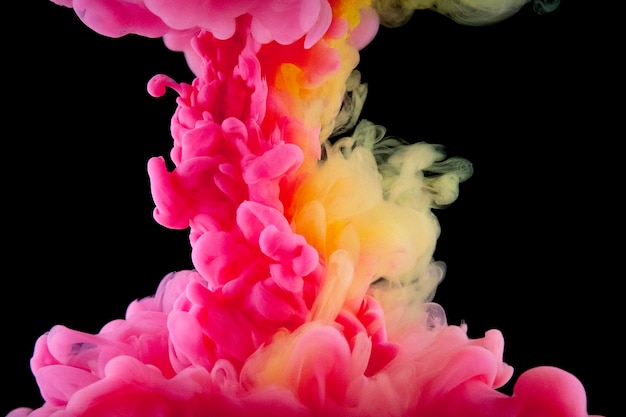 Pink and yellow paint swirling underwater