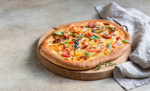 Pinsa with vegetables and cheese, concrete background. Traditional rome pizza.