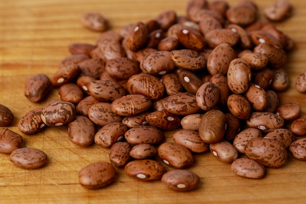 Pinto beans are dried on a wooden board