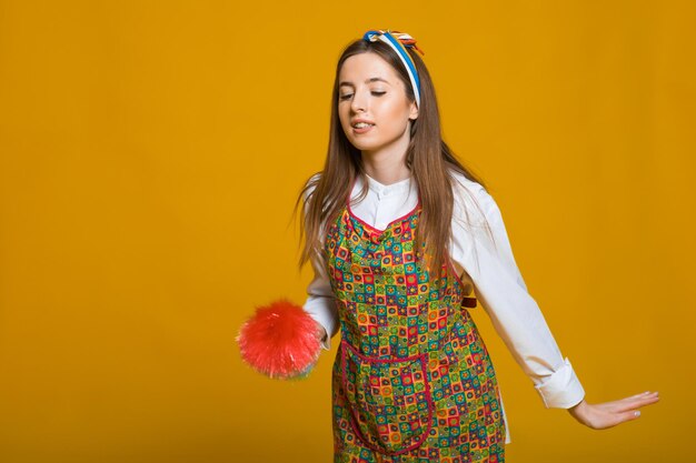 Pinup woman hold soup bottle duster pinup woman with happy face on yellow background