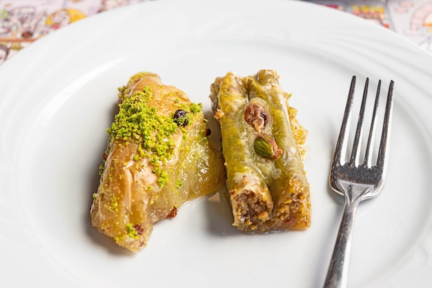 Pistachio baklava, a traditional Turkish and Mediterranean dessert served on a white plate