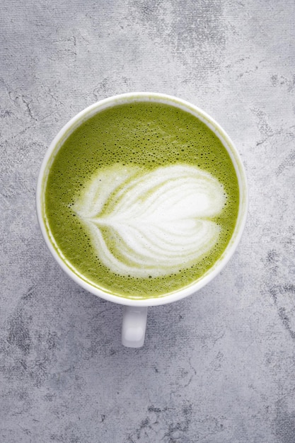 Pistachio cappuccino in a white cup on light