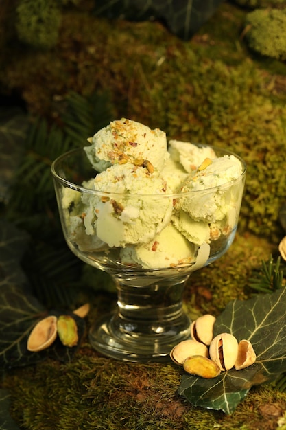 pistachio ice cream with nuts on green nature  background