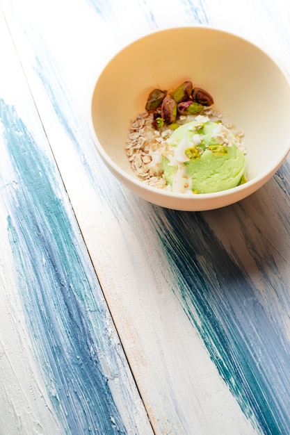 Pistachio ice cream with white chocolate on modern table. Healthy food. Vegan food