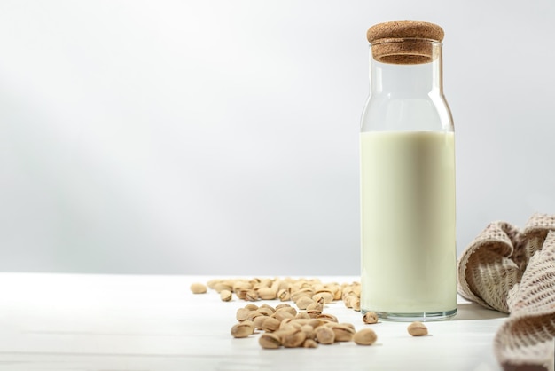 Pistachio milk on a light background with empty space for text