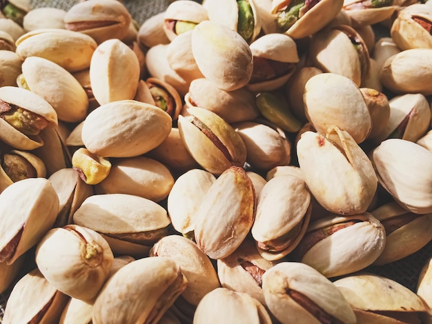 Pistachio nuts on rustic linen background