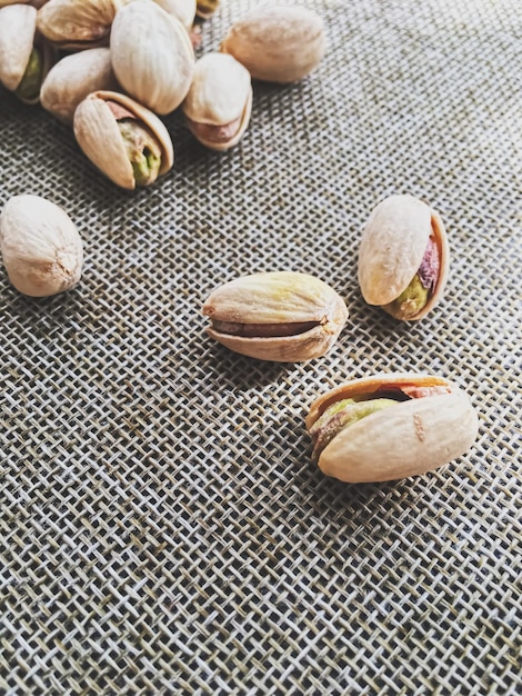 Pistachio nuts on rustic linen background