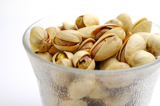 Pistachio nuts on white background : healthy food concept.