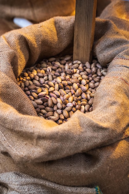 Pistachios in burlap sack at the market. Organic pistachios in bag in Catania Sicily, Italy.