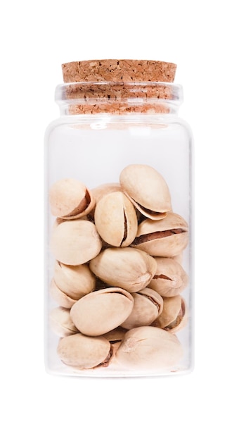 Pistachios in a glass bottle with cork stopper isolated on whit