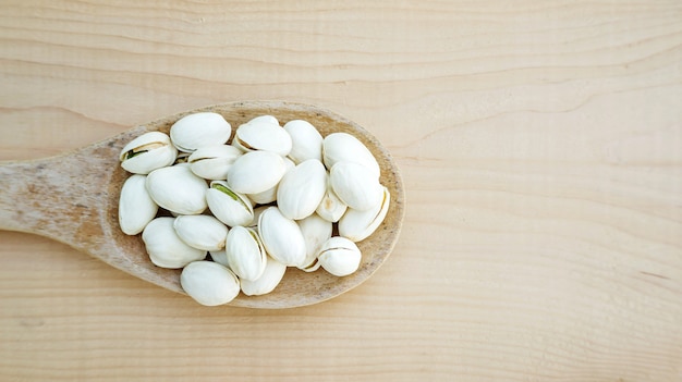 Pistachios on a wooden table.