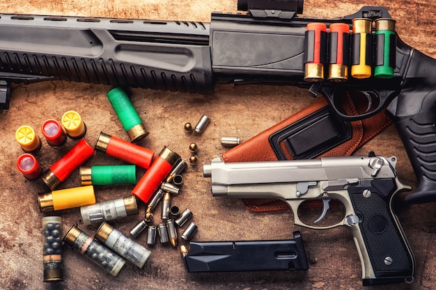 pistol gun bullets and magazine strewn on wooden table