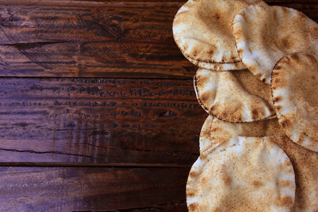 Pita bread isolated on rustic wooden table