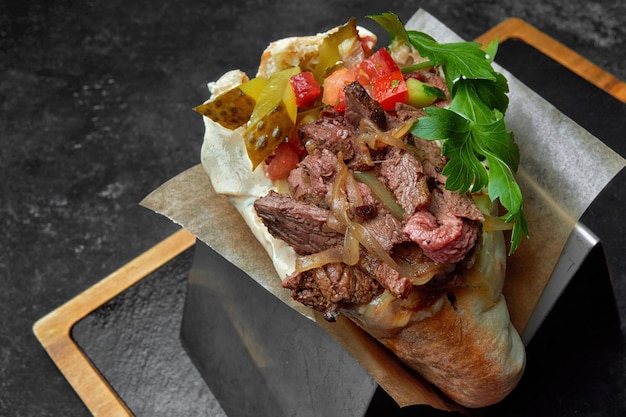 pita with beef vegetables and parsley on a dark background