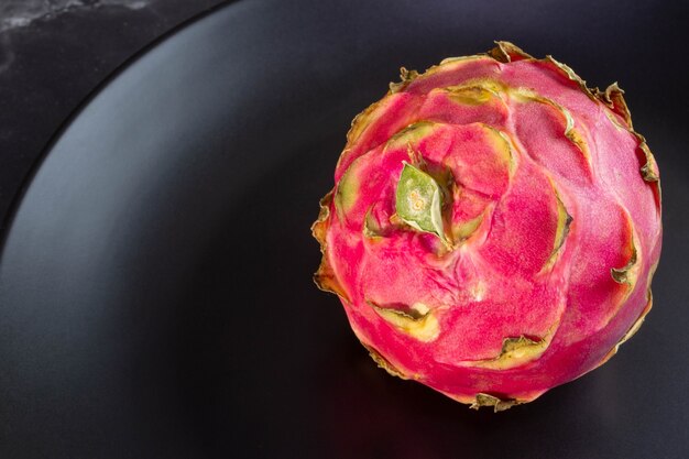 Pitaya fruit on black plate