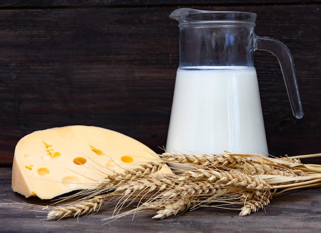 Pitcher with milk cheese wheat and fruits Shavuot concept