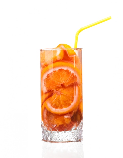 Pitcher with a refreshing drink with lemon slices of orange and kiwi on white background