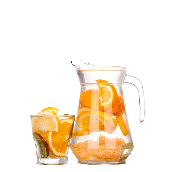 Pitcher with a refreshing drink with lemon slices of orange and kiwi on white background