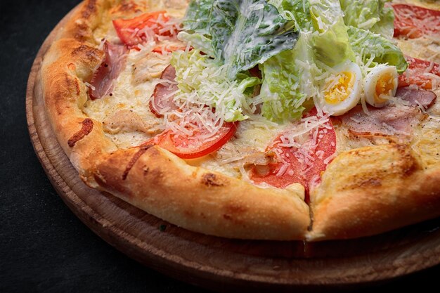 Pizza Caesar on a round wooden board