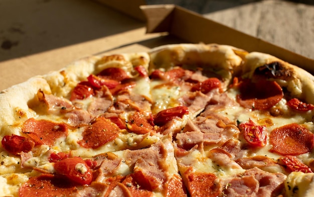 Pizza in a cardboard box on a dark chalkboard Top view of pizza package Pizza delivery