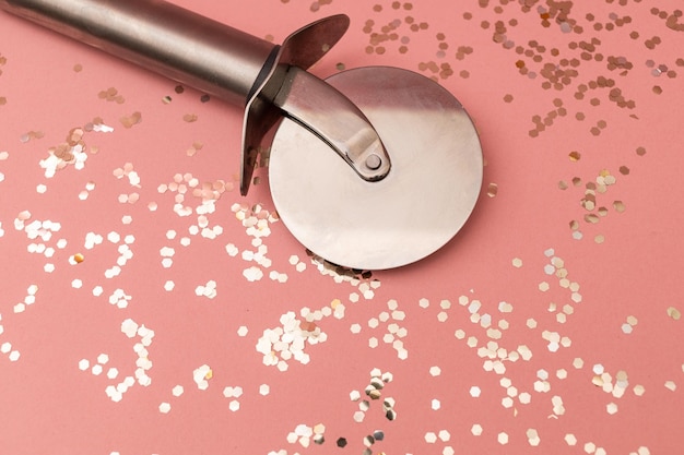 Pizza cutter on a pink background