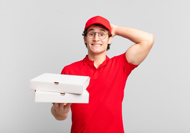 Pizza deliver boy feeling stressed, worried, anxious or scared, with hands on head, panicking at mistake