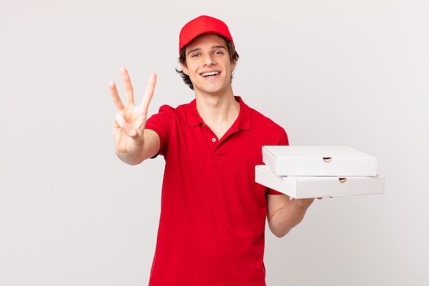 Pizza deliver man smiling and looking friendly, showing number three