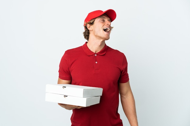 Pizza delivery man over isolated white background laughing