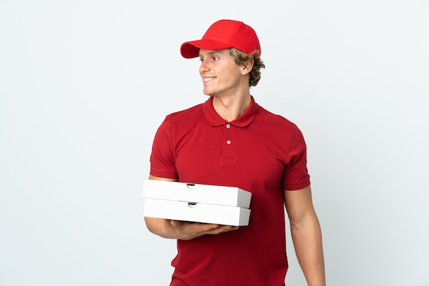 Pizza delivery man isolated white background looking to the side and smiling