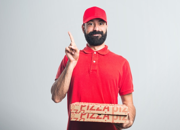 Pizza delivery man pointing up