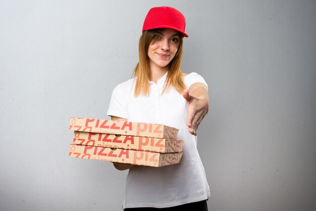 Pizza delivery woman making a deal on textured background