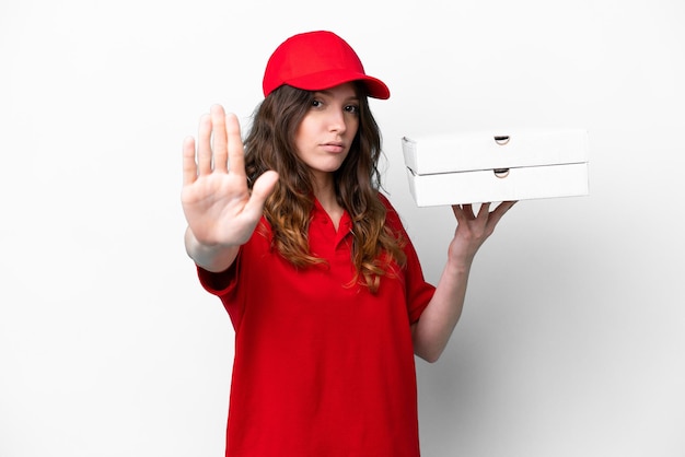 Pizza delivery woman with work uniform picking up pizza boxes isolated on white background making stop gesture