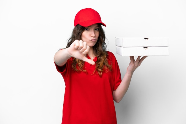 Pizza delivery woman with work uniform picking up pizza boxes isolated on white background showing thumb down with negative expression