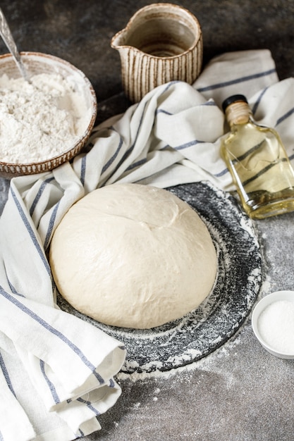 Pizza dough on rustic background Ingredients for making dough