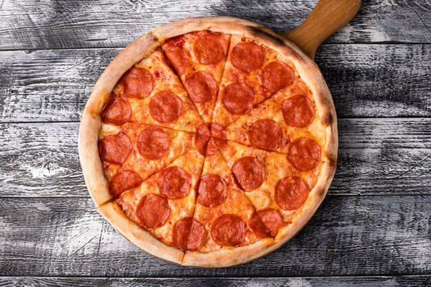 Pizza hot pizza on a white wooden background side and top view