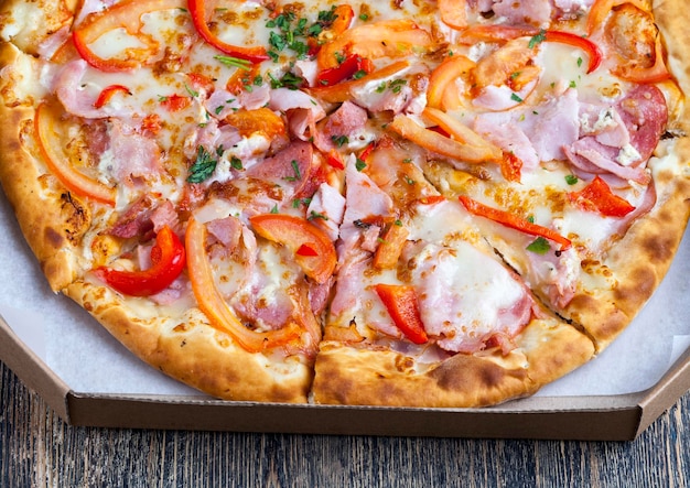 pizza made from dough, cheese, tomatoes, piece of meat, ketchup and other ingredients, delicious pizza from different ingredients